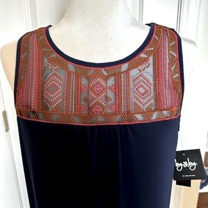 Navy dress with embroidered neckline and keyhole back.